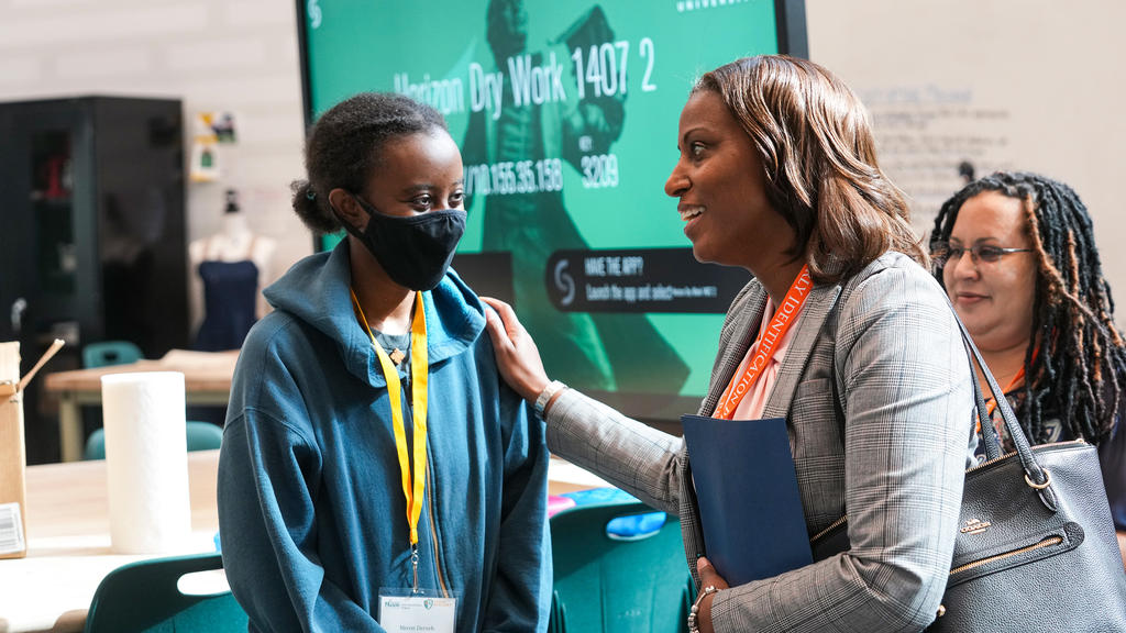 Superintendant LaTanya D. McDade, Ed.D. talks to a student with one hand on her shoulder in an EIP classroom.