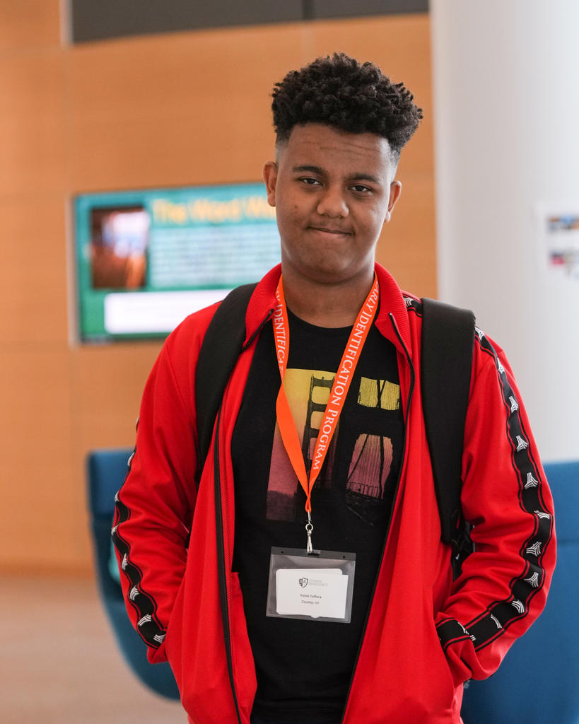 Student wearing an EIP lanyard poses for camera.